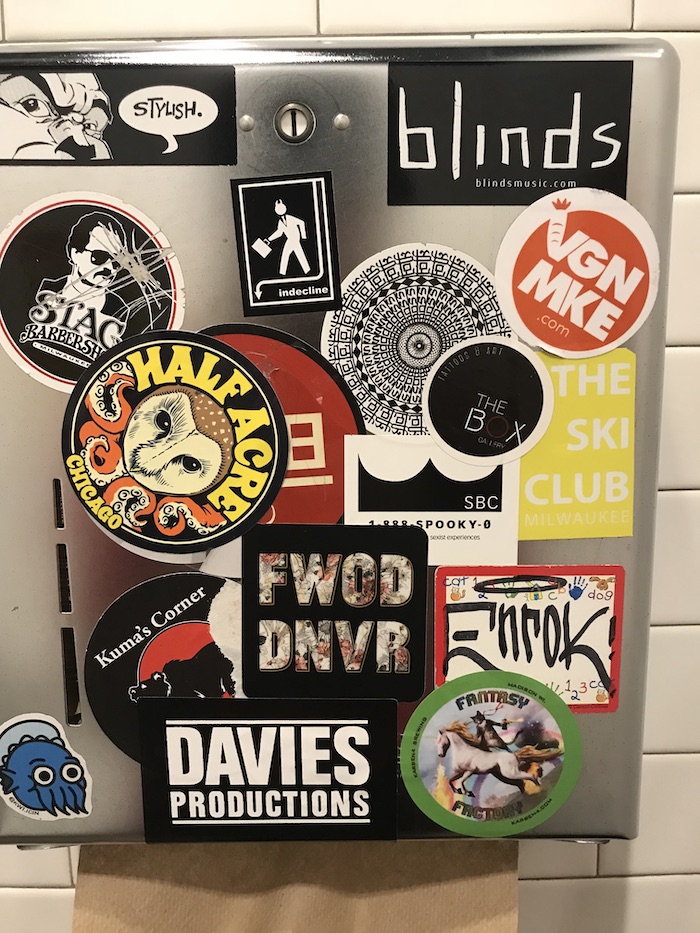 Sticker-covered paper towel dispenser